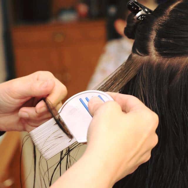 person receiving professional head lice comb out